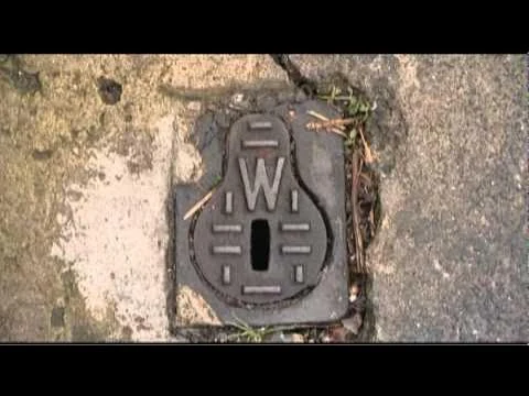 Older metal external water stopcock cover marked W